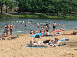 Plaża w Arturówku - ludzie kąpią się w wodzie i opalają się na piasku